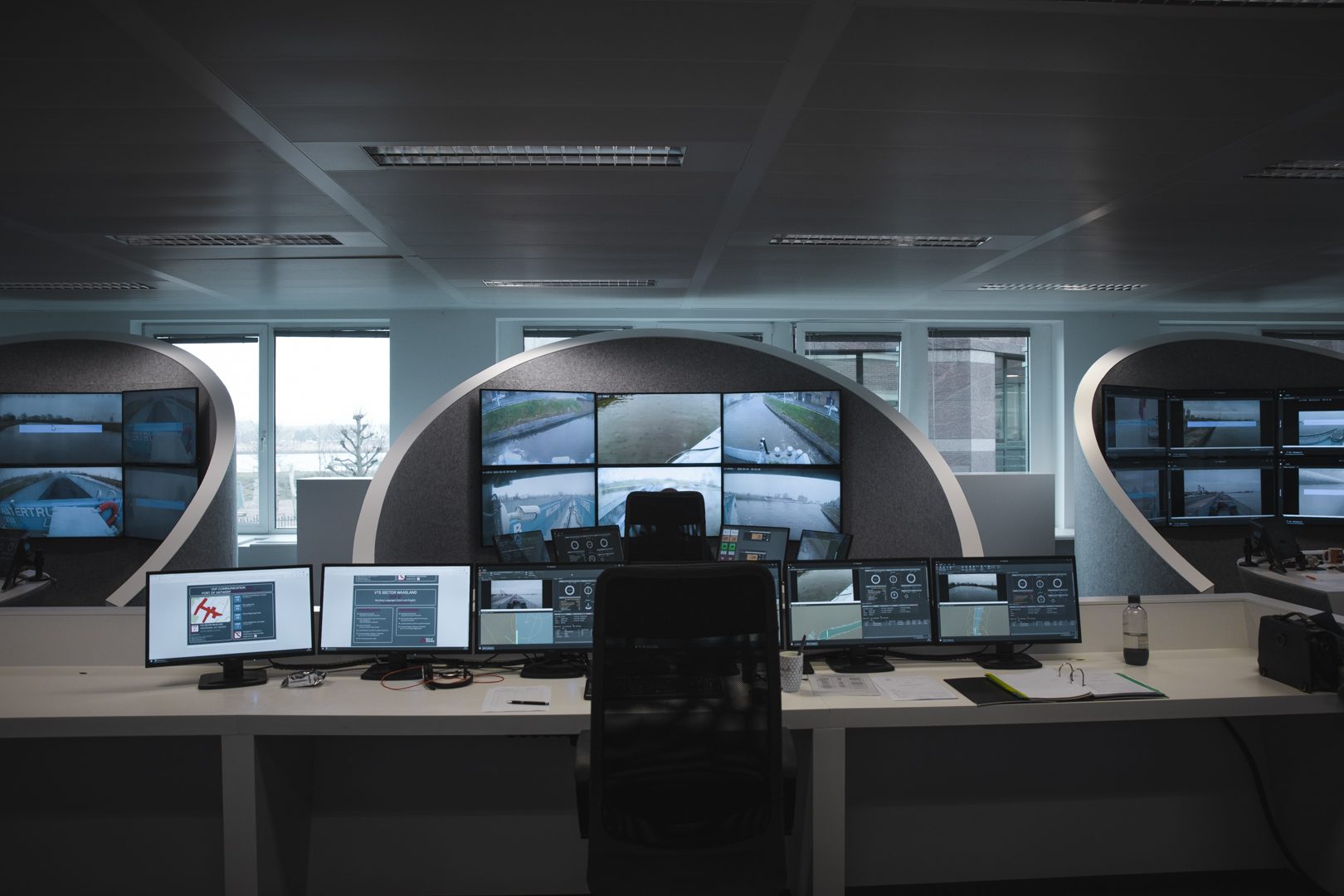 An unoccupied remote operation station in a Seafar Remote Operation Centre, with the camera wall showing live views from an inland vessel