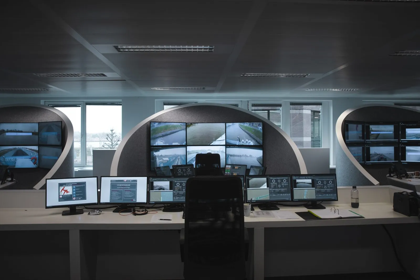 Remote Operation Center with workstations and camera feeds from inland vessels