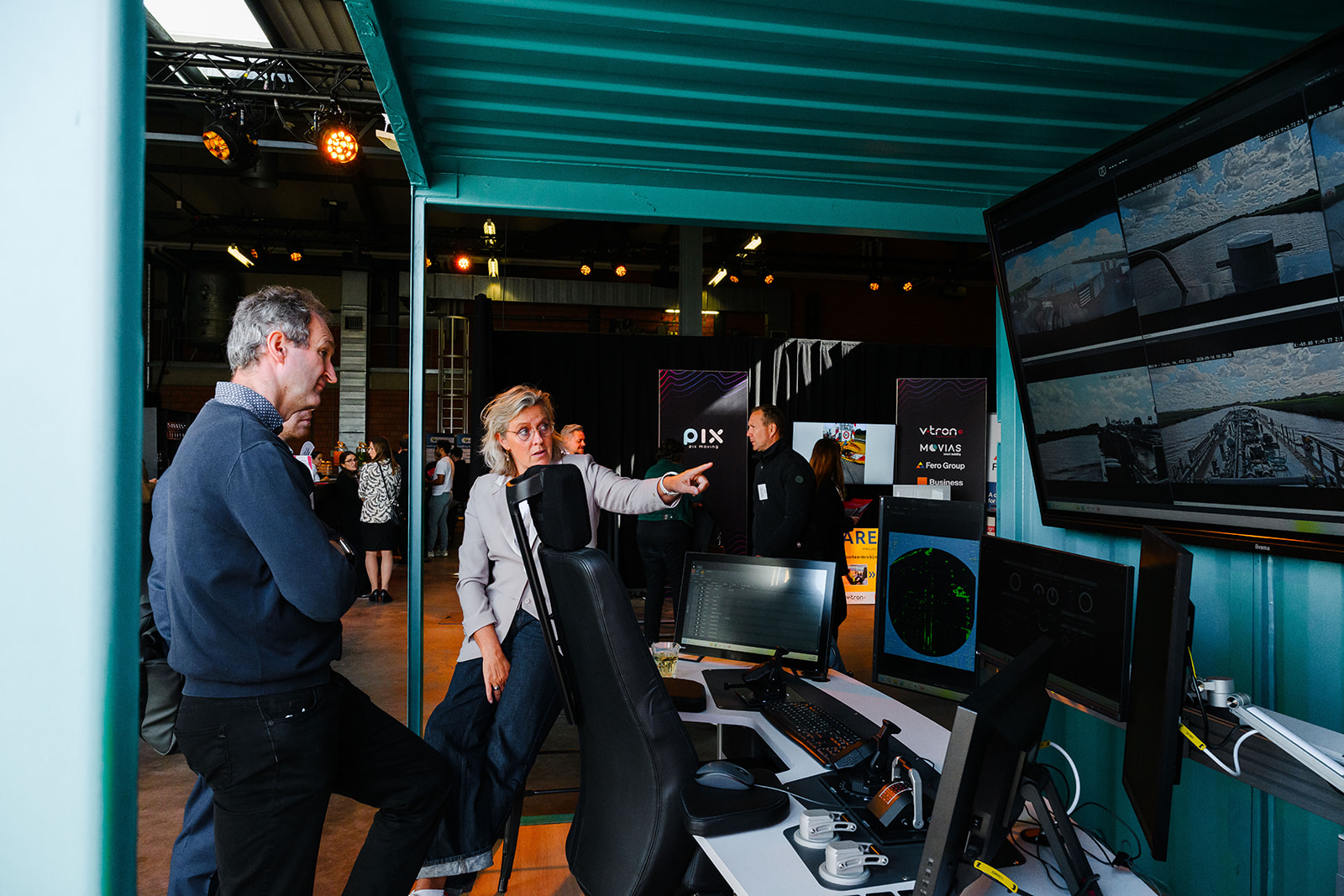 Visitors viewing a Seafar remote vessel operation station at the Autonomous Summit at Port of Antwerp-Bruges