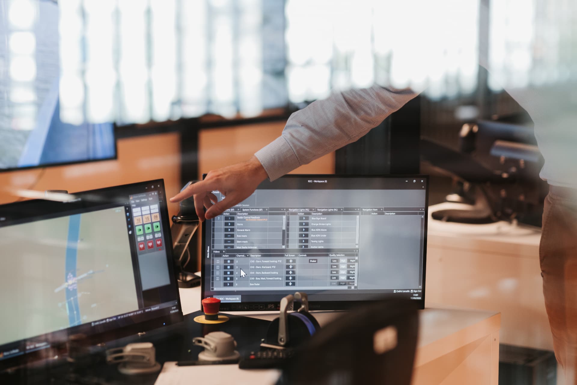 A remote operator pointing at vessel control software at a Seafar Remote Operations Center workstation