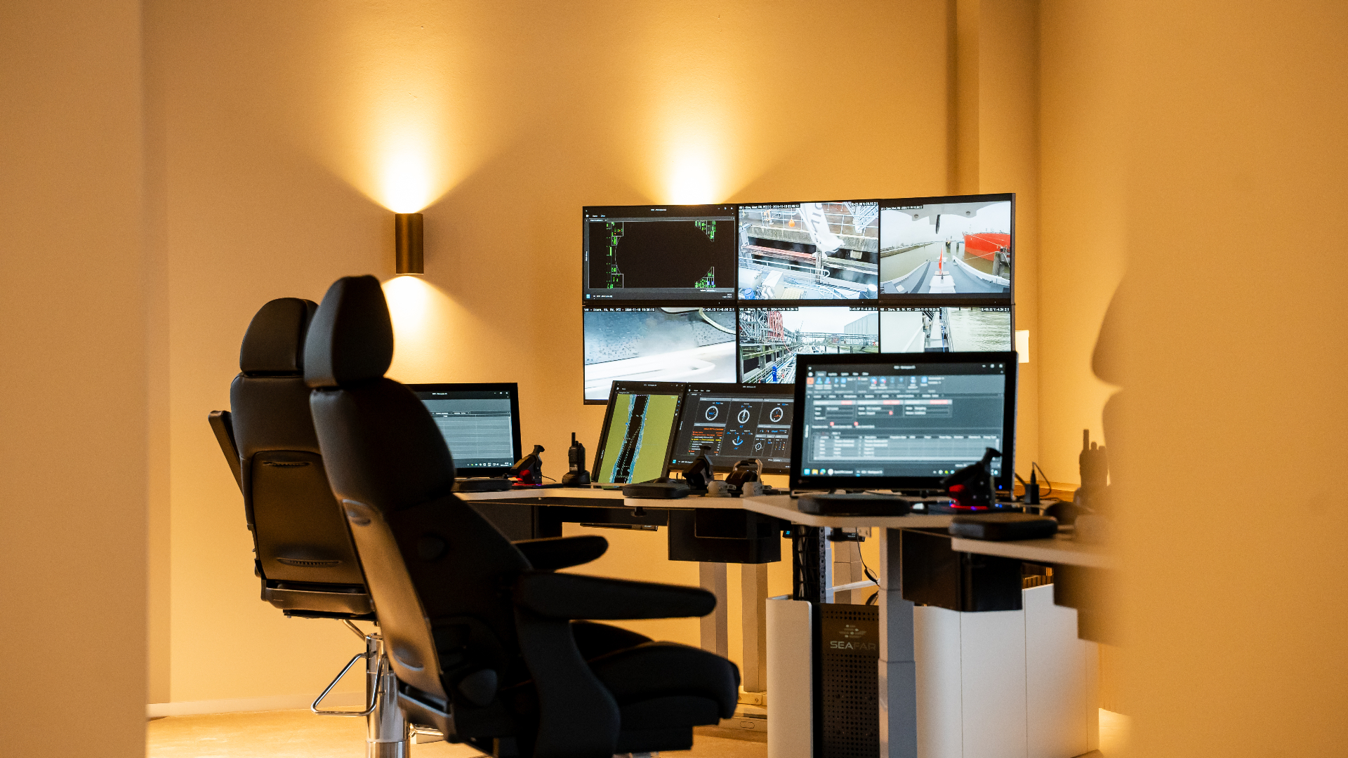 Seafar remote operator at an ROC workstation monitoring vessel cameras and navigation screens